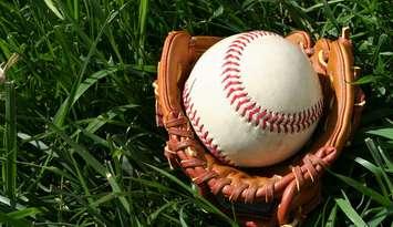 A baseball glove with a baseball. © Can Stock Photo Inc. / rmarmion